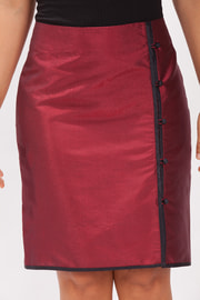 natural silk pencil skirt in dark red with contrasting black piping, covered buttons, side slit